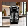 12-cup drip coffee maker with glass carafe placed on a modern kitchen countertop