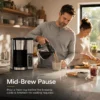 Coffee maker brewing fresh coffee into a large glass carafe