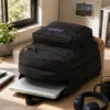 Black 34L laptop backpack with multiple compartments and laptop shown on a desk